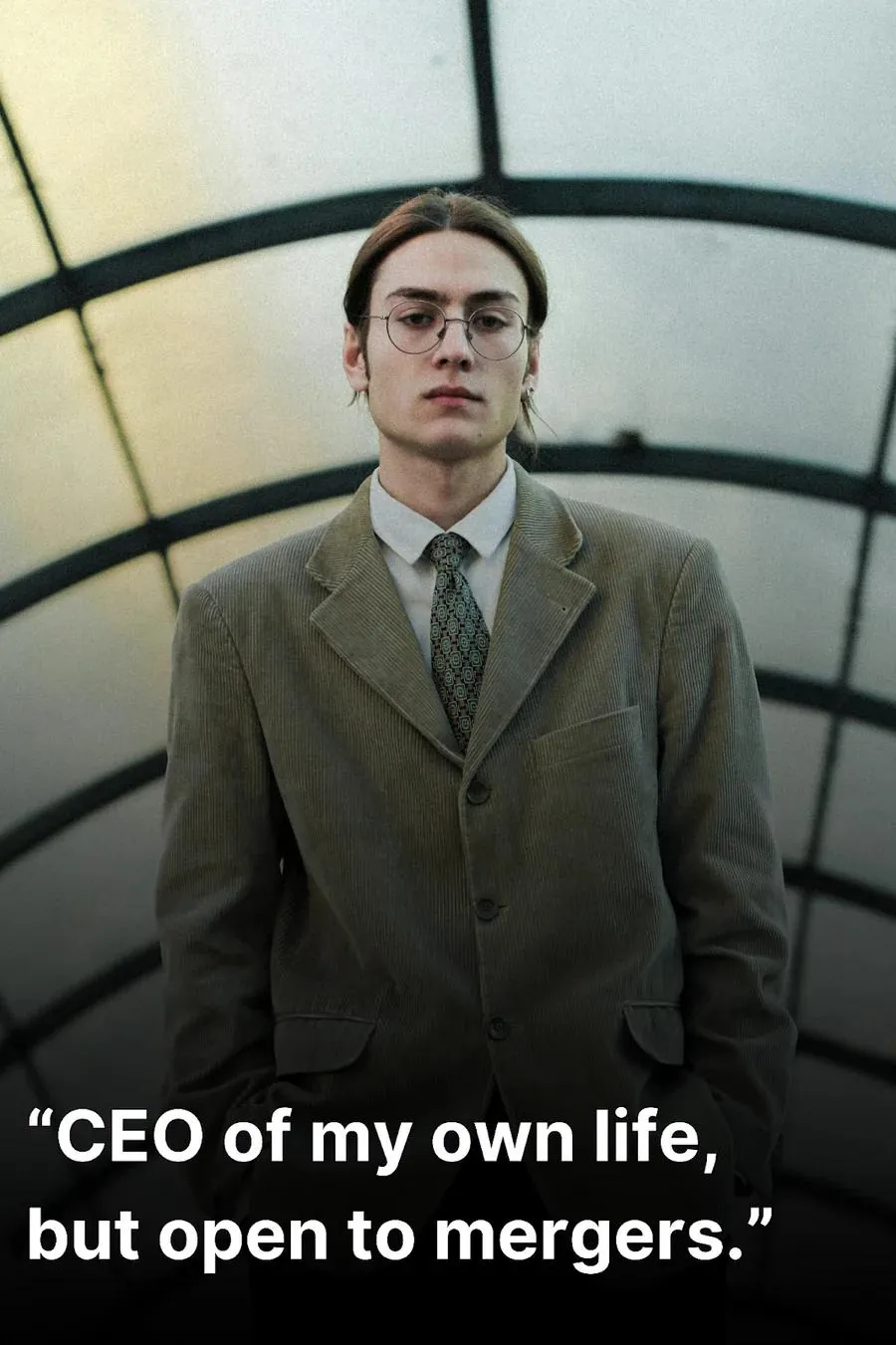 Confident young man wearing a grey suit coat
