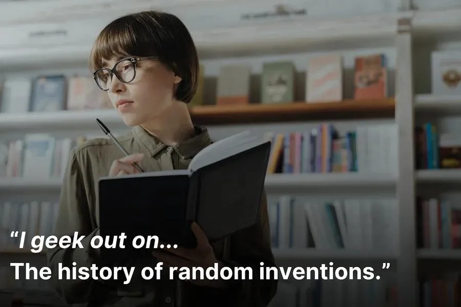 A woman reading a book and holding a pen