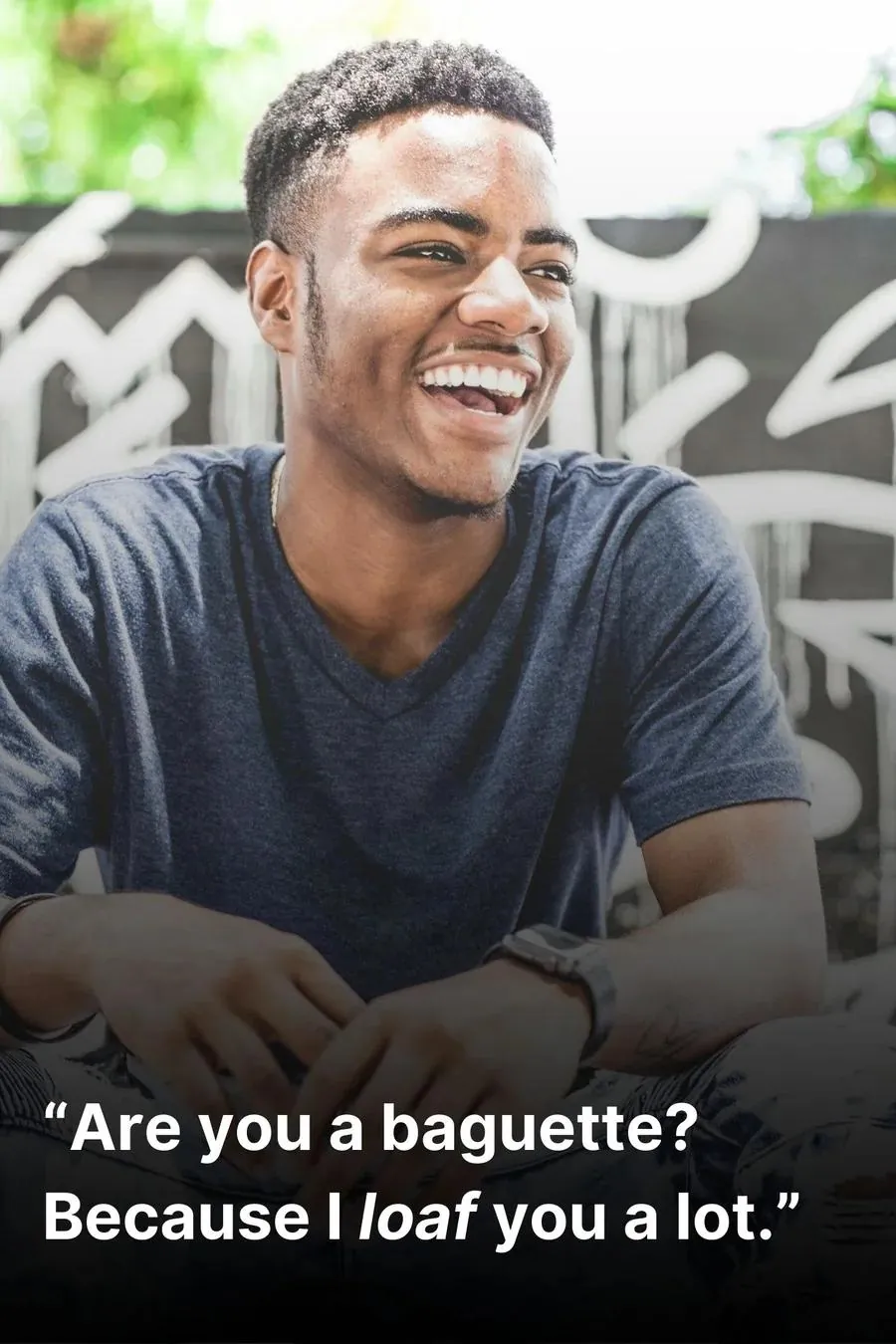 Young man, in a blue t-shirt, laughing