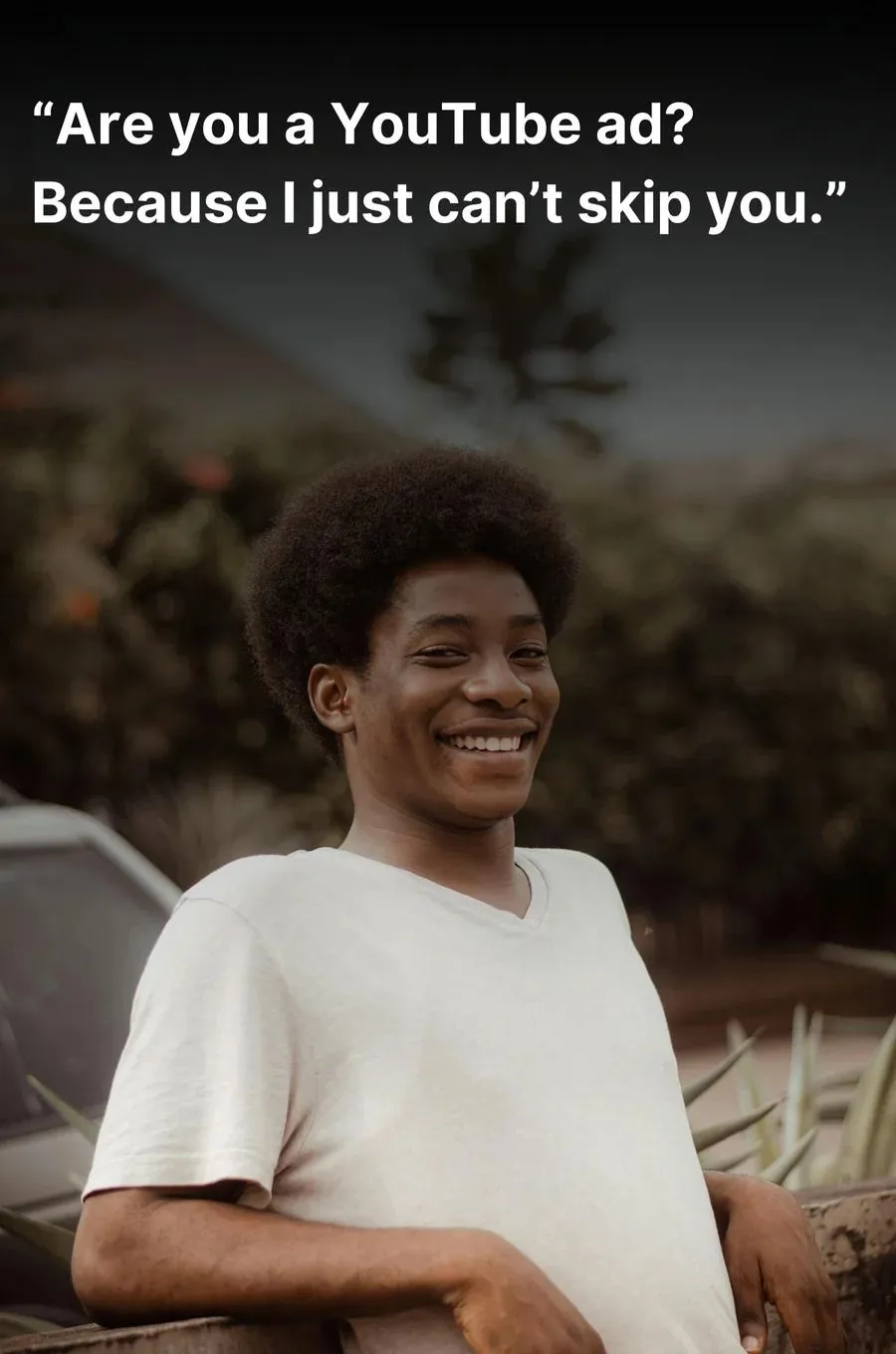 Man in a white t-shirt with a big smile