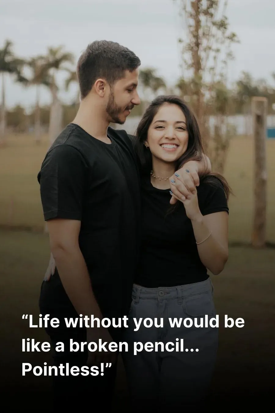 Young couple hugging, both wearing jeans and black t-shirts